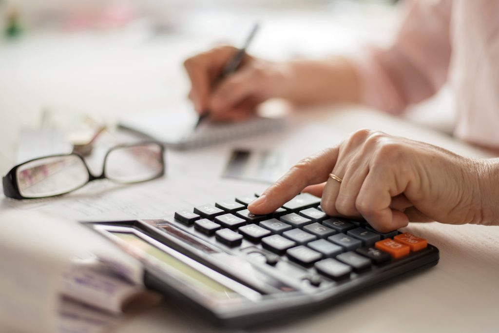 close up of a hand using a calculator