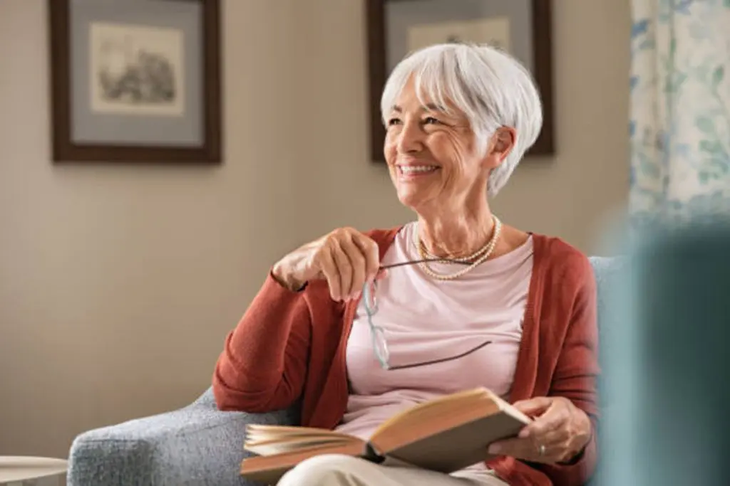 Happy mature woman wears a pink t-shirt reading 