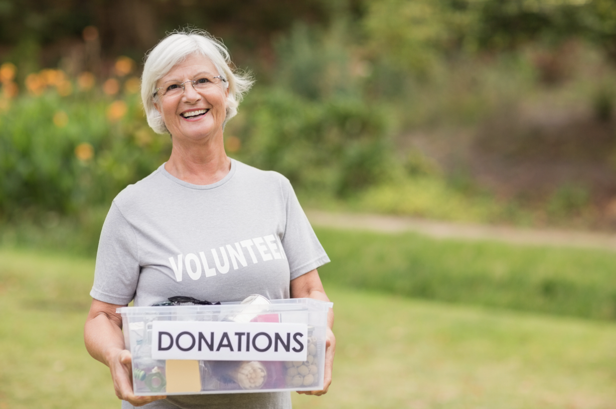 Happy mature woman wears a grey t-shirt reading 