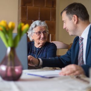 Man and older woman looking at computer.