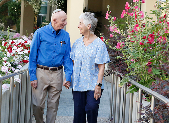 elderly couple walking hand in hand